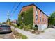 Brick building with green ivy and a sidewalk alongside a city street at 2 Francis St # I, Charleston, SC 29403