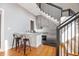 An efficient kitchen features light grey cabinets, bar seating, and stairs to another level at 2 Francis St # I, Charleston, SC 29403