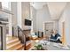 Open-concept living area featuring hardwood floors, a cozy fireplace and a couch at 2 Francis St # I, Charleston, SC 29403