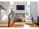 Cozy living room featuring a fireplace, stairs and hardwood floors, bathed in light at 2 Francis St # I, Charleston, SC 29403