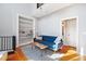 Stylish living room with a bright blue couch, built-in shelving, and hardwood floors at 2 Francis St # I, Charleston, SC 29403