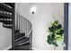 Modern spiral staircase with sleek black metal design and natural light at 2 Francis St # I, Charleston, SC 29403