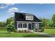 Charming two-story home with dark siding, black roof, a covered porch and well-maintained landscaping at 2048 Ten Point Dr, Charleston, SC 29492