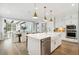 Beautiful kitchen featuring white cabinets, stainless steel appliances, quartz countertops, and view to the living room at 2048 Ten Point Dr, Charleston, SC 29492