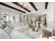 Spacious living room flows to the kitchen area with an open floor plan, lots of natural light, and wood beam ceilings at 2048 Ten Point Dr, Charleston, SC 29492