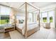 Serene primary bedroom boasts a king bed, tray ceilings, multiple windows, and neutral color scheme for relaxation at 2048 Ten Point Dr, Charleston, SC 29492