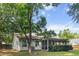 Beautiful home featuring a screened porch and spacious yard with lush green grass and mature trees at 210 Basswood Ave, Summerville, SC 29483