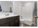 Bright bathroom with dark vanity, shower-tub combo, and stylish fixtures, creating a relaxing space at 210 Basswood Ave, Summerville, SC 29483