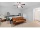 Bedroom with a ceiling fan, neutral carpet, a bed, sofa, and en suite bathroom at 210 Basswood Ave, Summerville, SC 29483