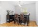 Charming dining area with modern light fixture, hardwood floors, and plenty of natural light at 210 Basswood Ave, Summerville, SC 29483