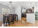 Elegant dining area featuring modern lighting, hardwood floors, and seamless transition to the kitchen at 210 Basswood Ave, Summerville, SC 29483