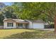 Inviting single-story home with a well-manicured lawn, a cozy front porch, and a two-car garage at 210 Basswood Ave, Summerville, SC 29483