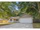 Inviting home featuring a two-car garage, a cozy front porch, and a well-maintained driveway at 210 Basswood Ave, Summerville, SC 29483