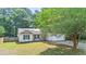 Charming single-story home featuring a cozy porch, two-car garage, and verdant lawn at 210 Basswood Ave, Summerville, SC 29483