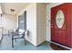Welcoming front porch with comfortable seating and a stylish red front door at 210 Basswood Ave, Summerville, SC 29483