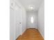 Well-lit hallway with hardwood floors leading to the front door at 210 Basswood Ave, Summerville, SC 29483