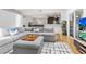Open living area featuring hardwood floors, sectional sofa, connecting to dining and kitchen spaces at 210 Basswood Ave, Summerville, SC 29483
