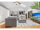 Spacious living area with hardwood floors, comfortable sectional sofa, and seamless transition to dining area at 210 Basswood Ave, Summerville, SC 29483