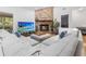 Comfortable living room featuring a cozy brick fireplace, media center, and neutral sectional sofa at 210 Basswood Ave, Summerville, SC 29483