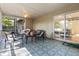 Screened porch with patterned floors, lounge furniture, and lots of light, perfect for outdoor relaxation at 210 Basswood Ave, Summerville, SC 29483