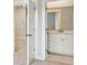 View of a bathroom from doorway with cabinets, marble countertop, mirror, and tiled floor at 211 Yalton St, Summerville, SC 29486
