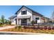 Charming white farmhouse-style store with a grey awning, black shutters, and landscaped surroundings at 211 Yalton St, Summerville, SC 29486