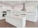 Bright kitchen features white cabinets, stainless steel appliances, a large island, and hardwood floors at 211 Yalton St, Summerville, SC 29486