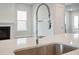 Close-up of a stainless steel sink and pull-down faucet set in a light countertop island at 211 Yalton St, Summerville, SC 29486