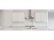Close-up of kitchen with white cabinets, stainless steel hood, sink in island, and white tile backsplash at 211 Yalton St, Summerville, SC 29486