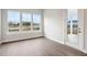 Spacious living room featuring large windows with hardwood floors and door leading outside at 211 Yalton St, Summerville, SC 29486