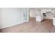 Open-concept living room with hardwood floors leading into a kitchen with white cabinets and island at 211 Yalton St, Summerville, SC 29486