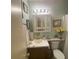A bright bathroom featuring a white vanity, decorative mirror, and fresh floral accents for a clean, inviting space at 214 Winter St, Moncks Corner, SC 29461