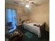 This charming bedroom has a daybed with floral pillows, with cozy lighting for a warm and restful atmosphere at 214 Winter St, Moncks Corner, SC 29461