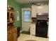 Efficient kitchen featuring white cabinets, black appliances, and a cozy dining area at 214 Winter St, Moncks Corner, SC 29461