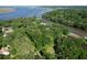 Aerial view of a waterfront property surrounded by mature trees with views of the river at 2180 Wappoo Hall Rd, Charleston, SC 29412