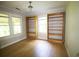Bedroom featuring hardwood floors, built-in bookshelves and dual windows offering great natural light at 2180 Wappoo Hall Rd, Charleston, SC 29412