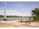 Scenic waterfront view featuring a concrete boat ramp and wooden pier extending into a tranquil river at 2180 Wappoo Hall Rd, Charleston, SC 29412