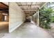 Open garage area with white paneled walls and a partial roof providing sheltered parking or storage at 2180 Wappoo Hall Rd, Charleston, SC 29412