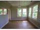 Bright living room featuring hardwood floors, large windows and neutral wall color creating a cozy and inviting atmosphere at 2180 Wappoo Hall Rd, Charleston, SC 29412