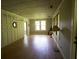 Open living room with hardwood floors, wainscoting, a unique porthole window, and neutral decor at 2180 Wappoo Hall Rd, Charleston, SC 29412
