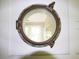 Close-up of a vintage-style porthole window offering a glimpse into an adjacent room at 2180 Wappoo Hall Rd, Charleston, SC 29412