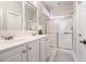 Well-lit bathroom with double sinks, sleek cabinetry, and a glass-enclosed shower at 2206 Magnolia Meadows Dr, Mount Pleasant, SC 29464