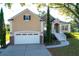Charming stucco and brick home featuring a two-car garage and inviting front entrance at 2206 Magnolia Meadows Dr, Mount Pleasant, SC 29464