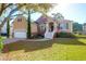 Lovely front lawn featuring a home with a charming entrance, two-car garage, and brick accents at 2206 Magnolia Meadows Dr, Mount Pleasant, SC 29464