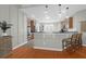 Stylish kitchen featuring hardwood floors, stainless steel appliances, and a breakfast bar with seating at 2206 Magnolia Meadows Dr, Mount Pleasant, SC 29464