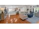 Open-concept living space featuring hardwood floors, a comfortable seating area, and a kitchen bar at 2206 Magnolia Meadows Dr, Mount Pleasant, SC 29464