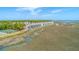 Aerial view of waterfront townhomes with screened balconies and marshland views at 221 E Mariners Cay # 221, Folly Beach, SC 29439