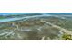 Sprawling aerial scene of waterfront homes nestled near marshland and a convenient roadway for easy access at 221 E Mariners Cay # 221, Folly Beach, SC 29439