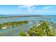 Stunning aerial view of waterfront homes nestled among lush trees and waterways, offering scenic coastal living at 221 E Mariners Cay # 221, Folly Beach, SC 29439