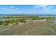Picturesque aerial view of waterfront community featuring lush trees and expansive marsh views at 221 E Mariners Cay # 221, Folly Beach, SC 29439